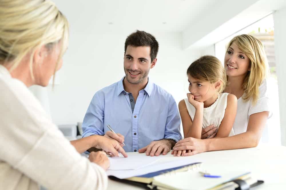 Family meeting real-estate agent for help to buy house investment