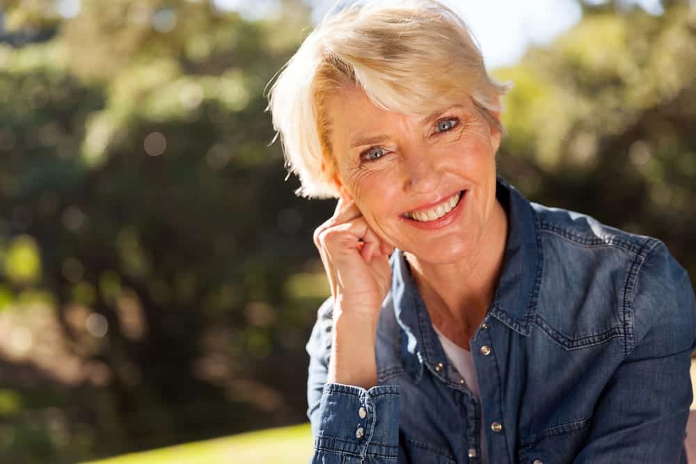 A smiling woman looking forward to retirement